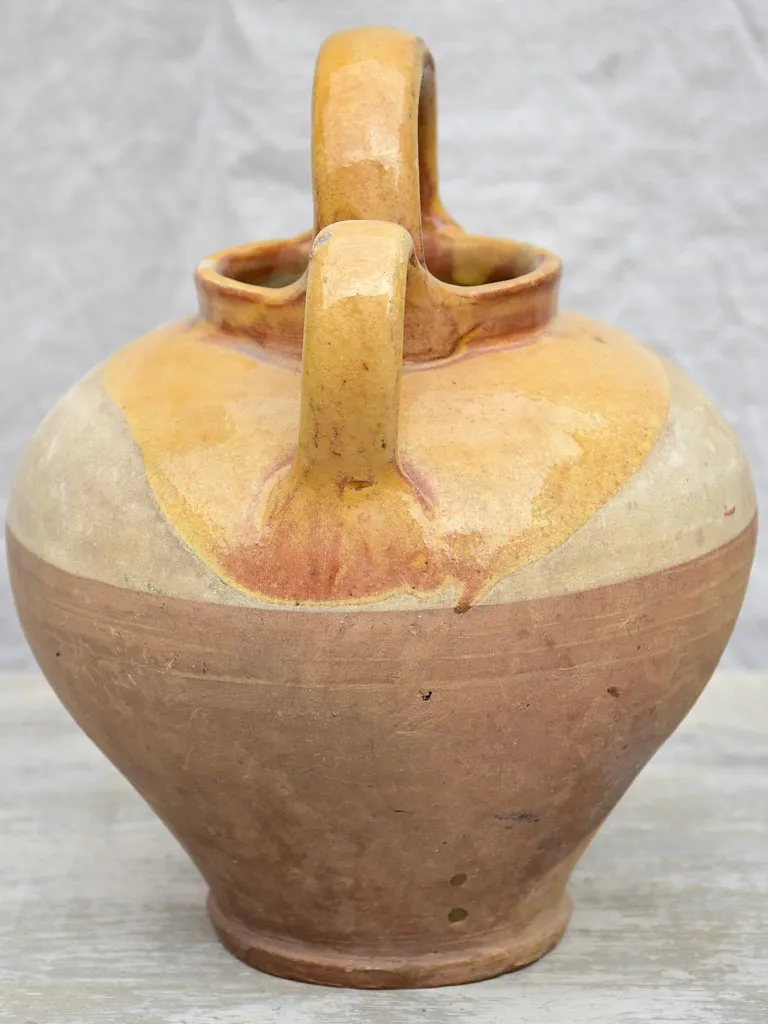 Antique French water pitcher with yellow glaze
